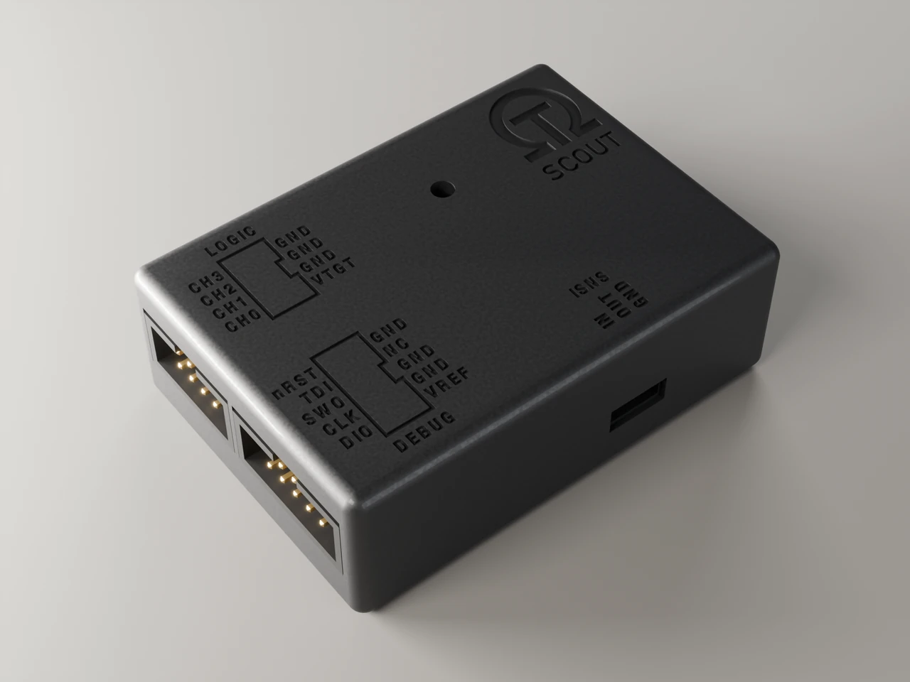 Scout wireless debug probe in its black case, with the SCOUT name and engraved pin labels on the lid